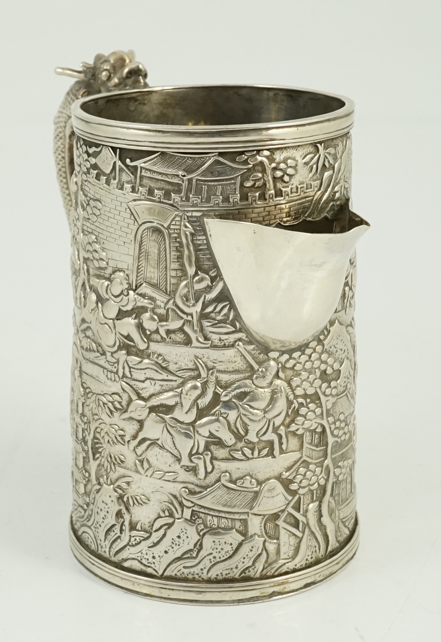 A Chinese embossed white metal mug, now converted to a jug, maker possibly LC or LO